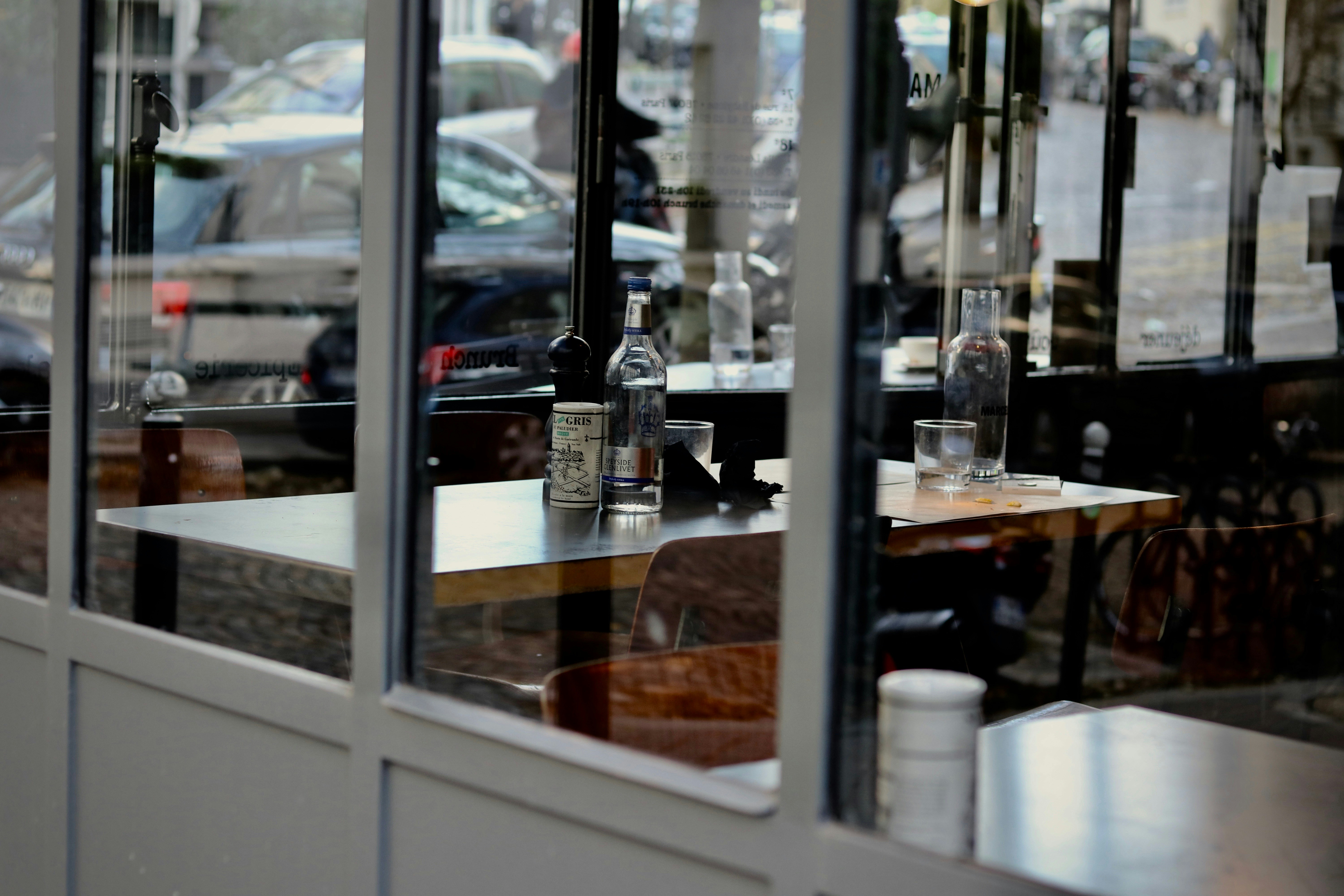 clear drinking glass on brown wooden table, 