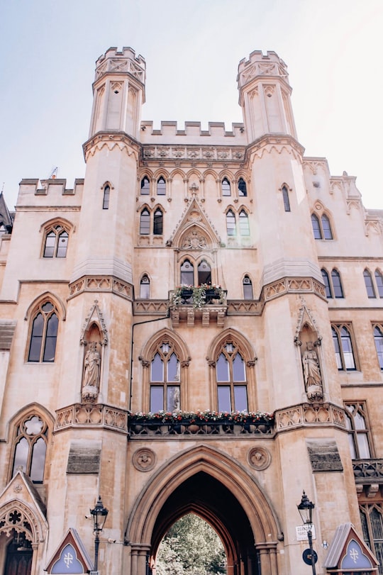 brown concrete building under blue sky during daytime in Westminster Abbey United Kingdom