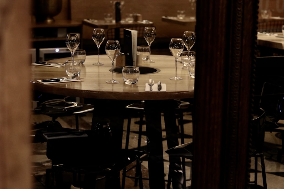 clear drinking glasses on brown wooden table,