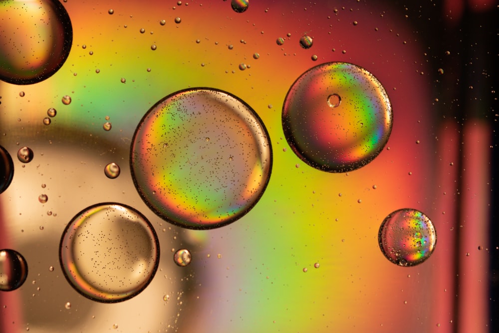 a close up of water bubbles on a colorful surface
