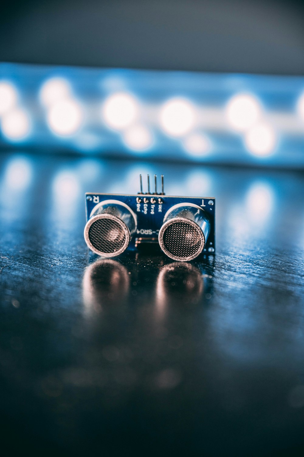 silver and blue round portable speaker