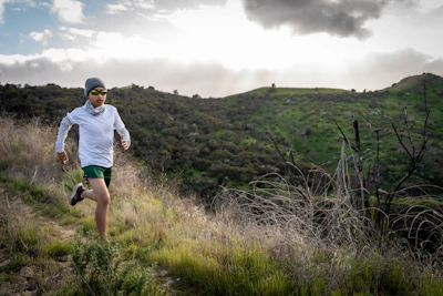 man in white shirt standing on green grass field during daytime