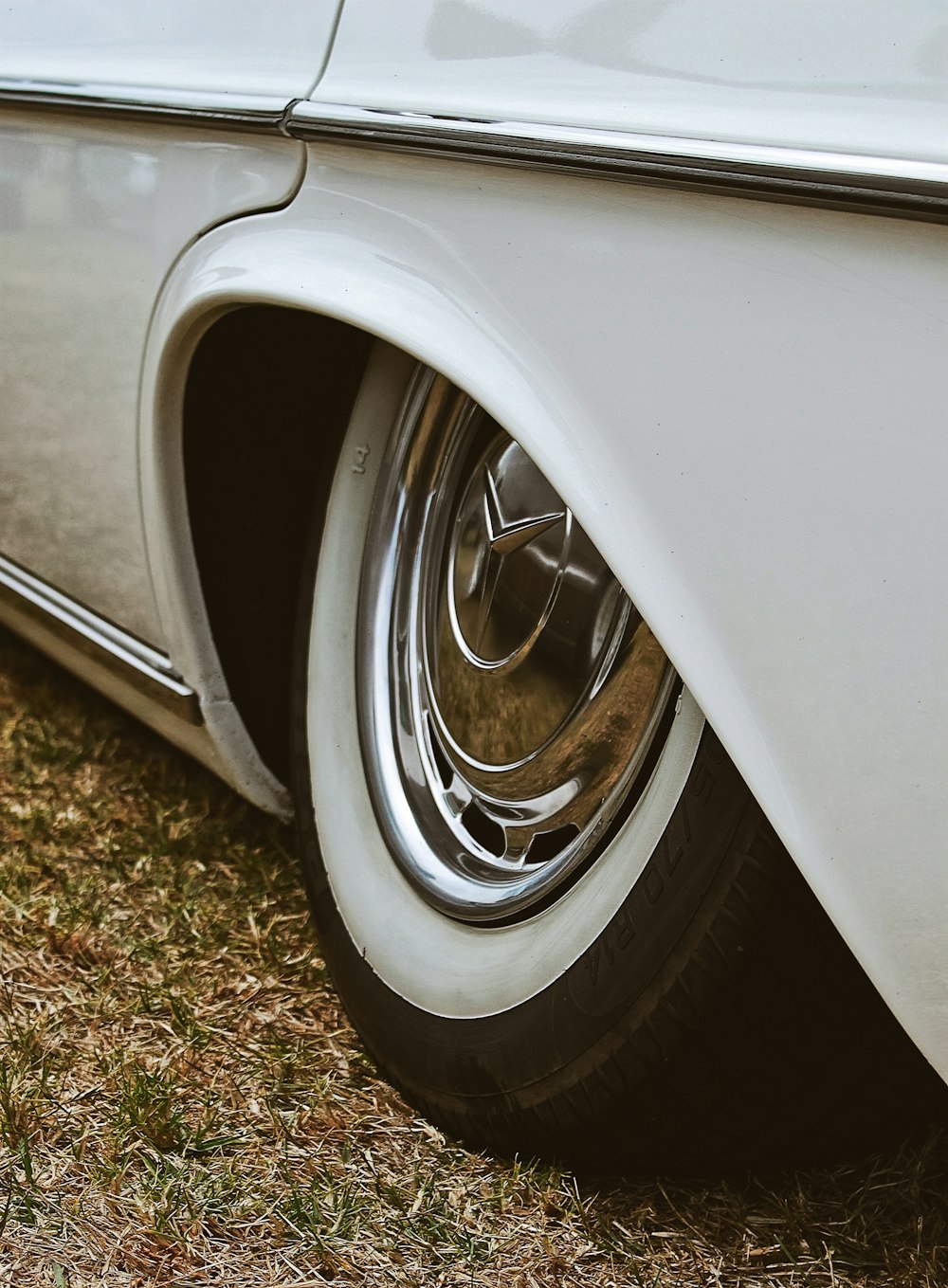 white car on green grass during daytime