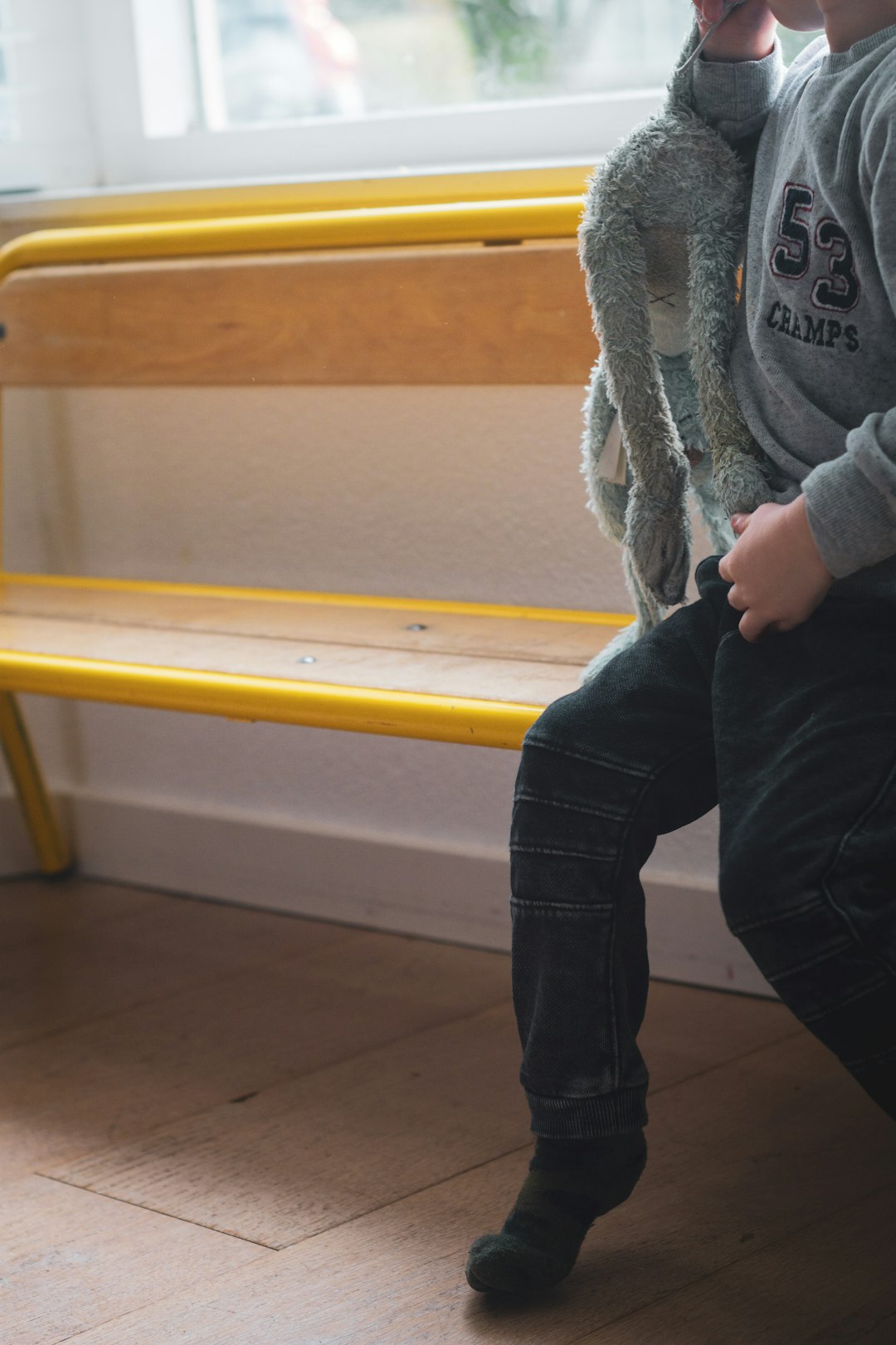 person in gray sweater and blue denim jeans