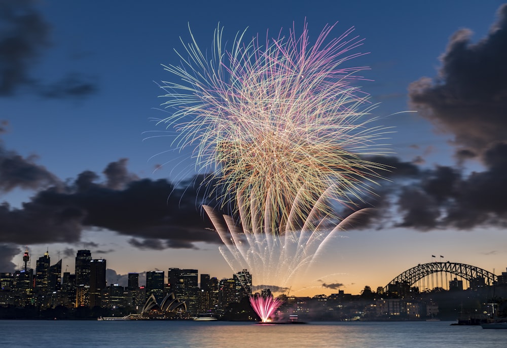 fireworks display over city buildings during night time