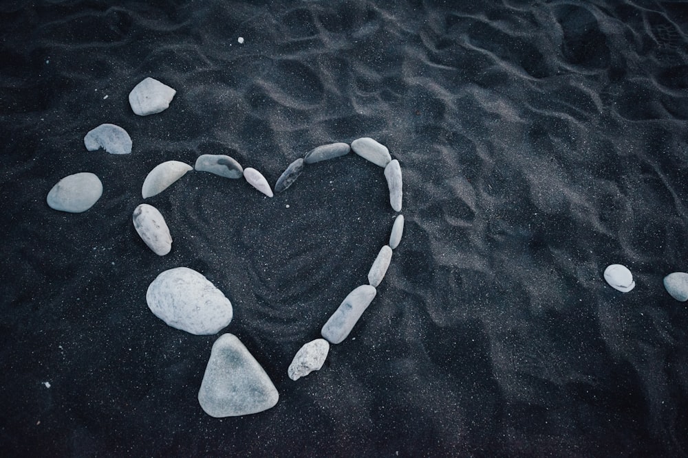 white heart shaped stones on blue water