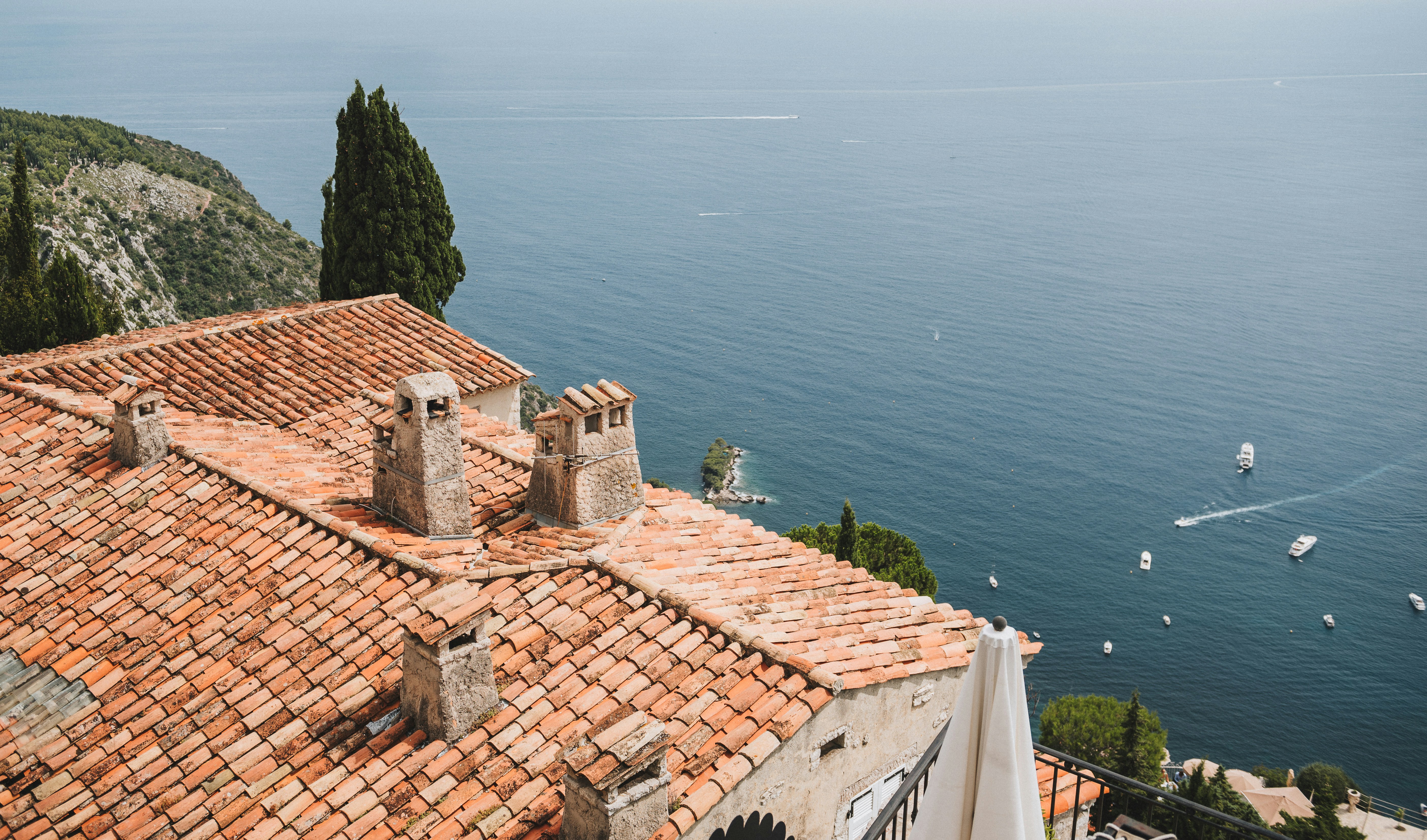 brown and white concrete house near body of water during daytime, Rooftops of old medieval houses in Eze village, in South of France near Nice and Cannes, Provence, French, Cote de Azur, Mediterranian sea 