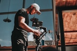 man in black t-shirt holding black camera