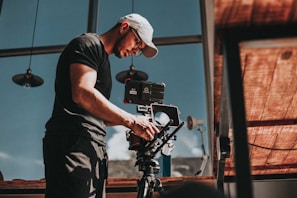 man in black t-shirt holding black camera