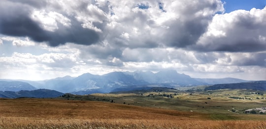 brown grass field under white clouds during daytime in Durmitor Montenegro