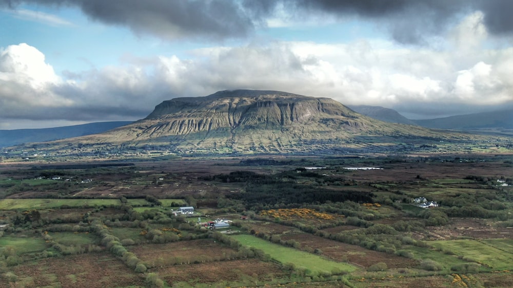 green and brown mountain under cloudy sky during daytime