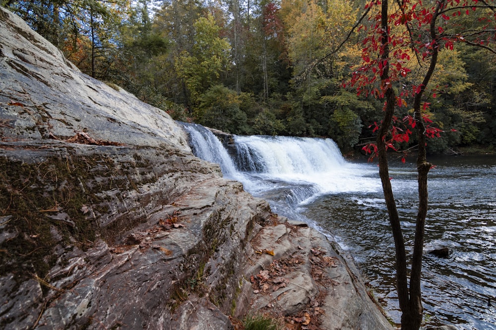 brown and gray rock formation with water falls