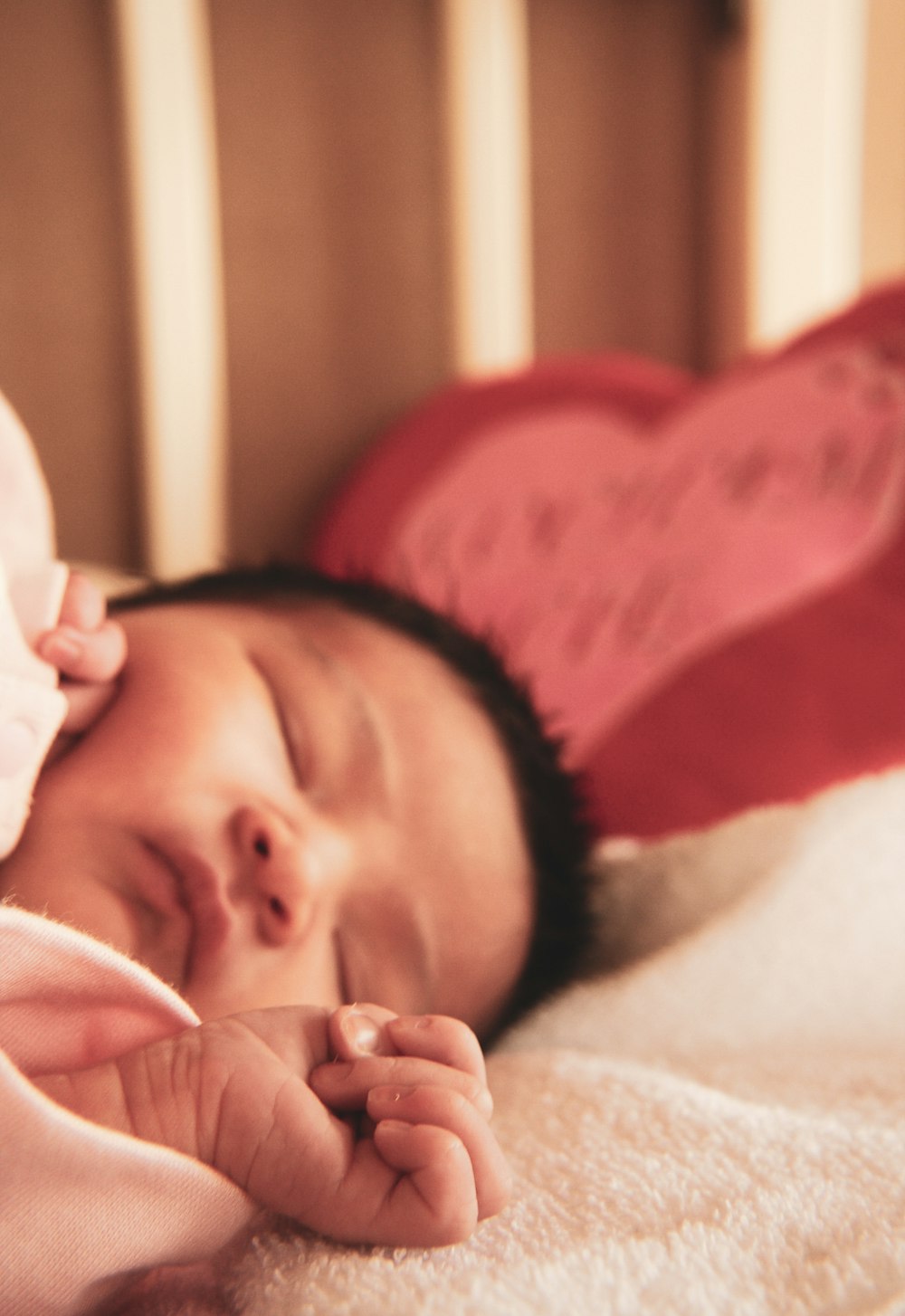 baby in white shirt lying on bed