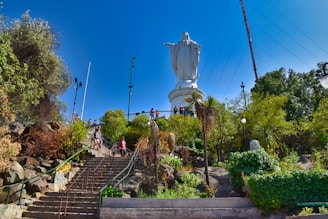 white angel statue on brown brick wall during daytime