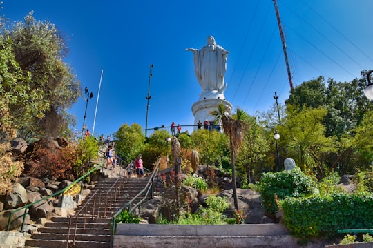 white angel statue on brown brick wall during daytime in Parque Metropolitano de Santiago Chile