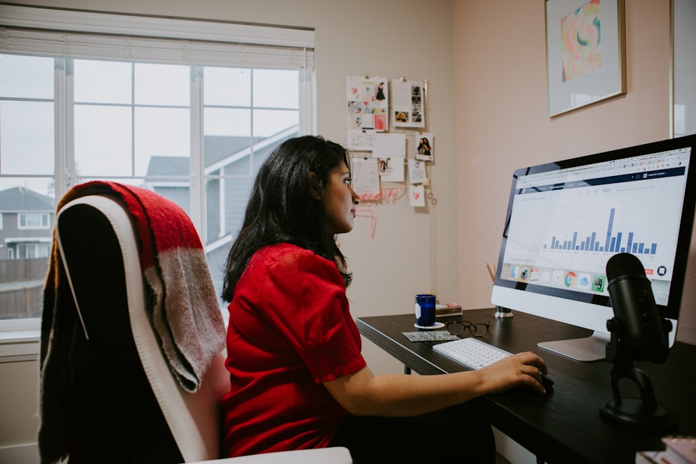 woman in red shirt sitting on chair