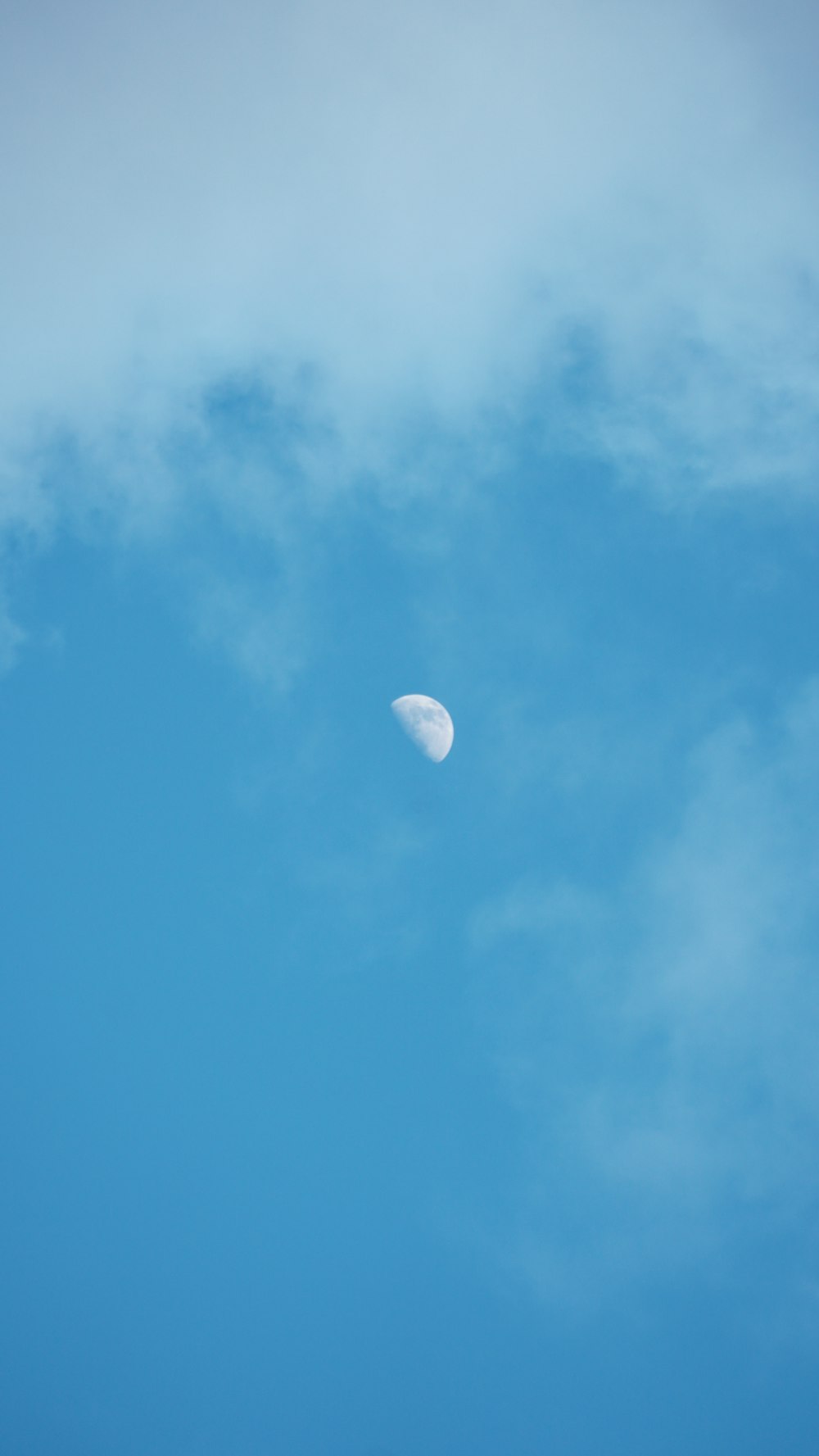 white moon in blue sky