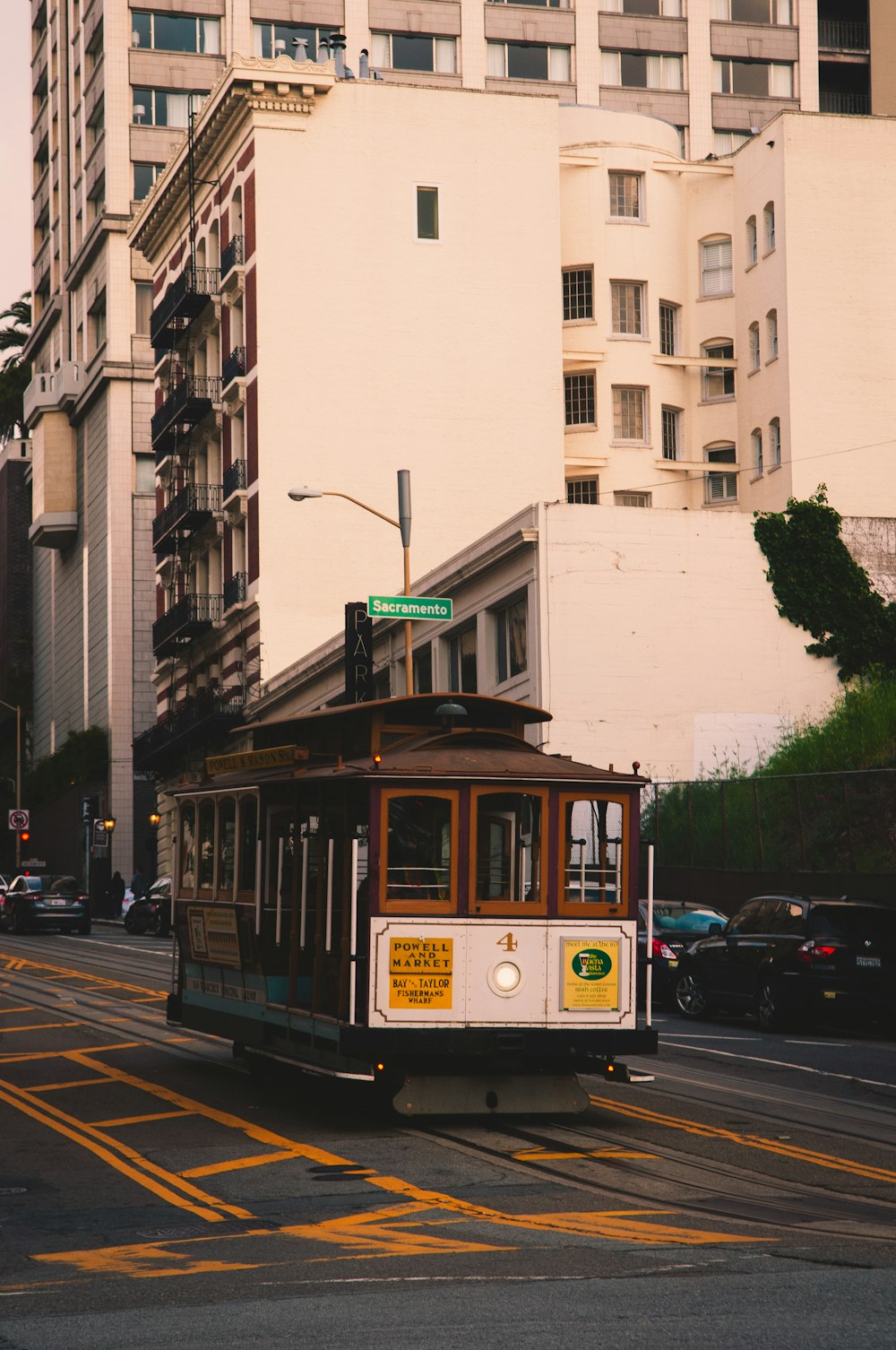 white and brown tram on road near building during daytime