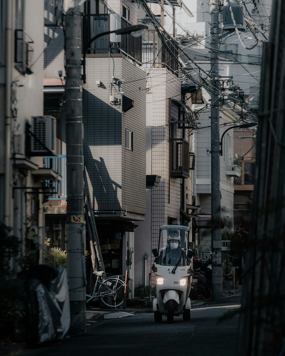 a car driving down a street next to tall buildings