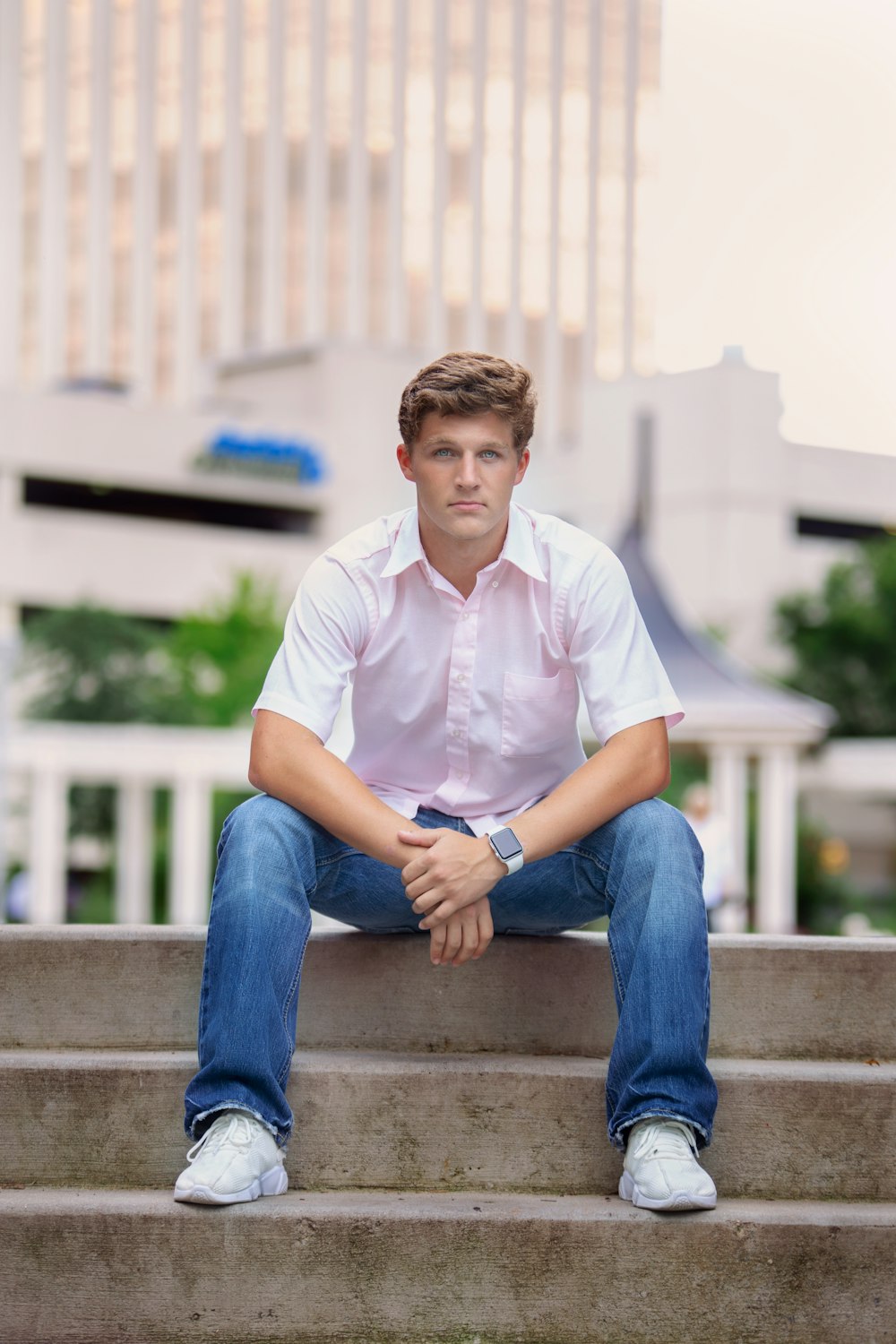 Man in white polo shirt and blue denim jeans sitting on concrete bench  during daytime photo – Free Charlotte Image on Unsplash