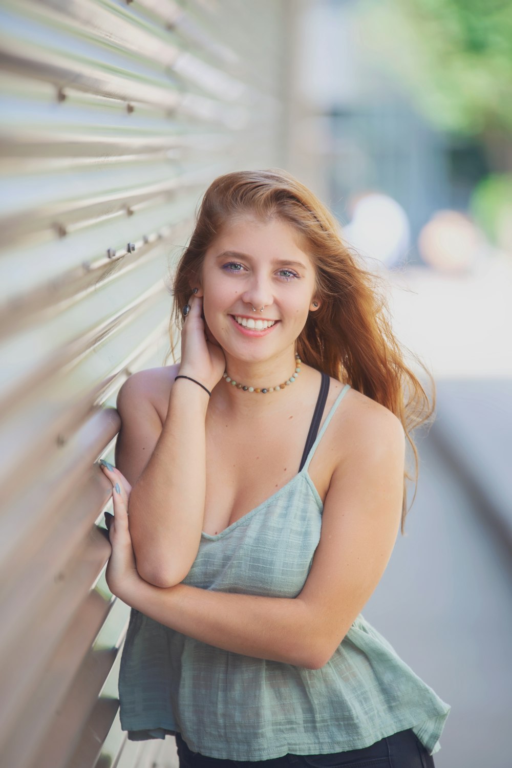 smiling woman in blue spaghetti strap top