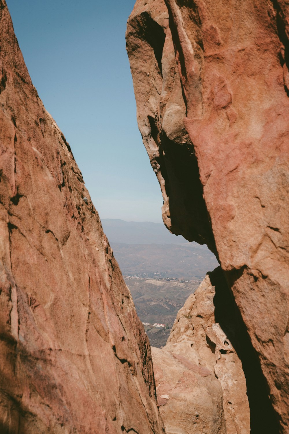 brown rock formation near body of water during daytime