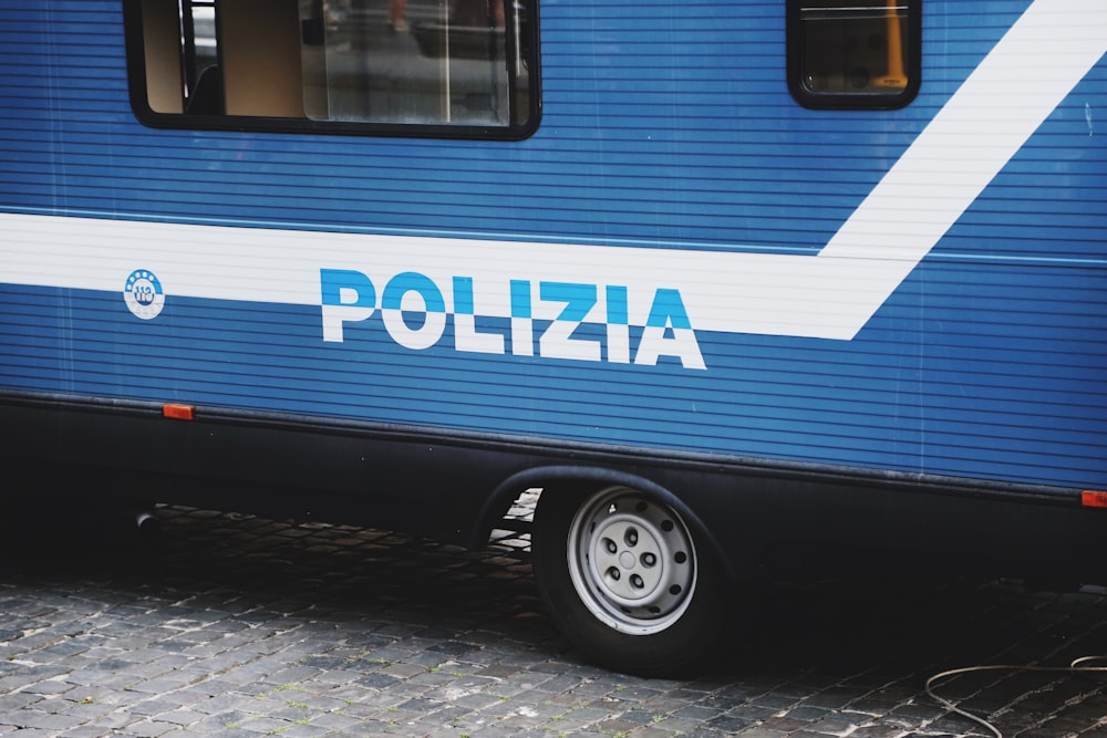 blue and white bus on road during daytime