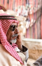 man in red and white scarf wearing gold framed aviator sunglasses