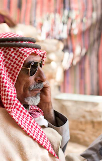 man in red and white scarf wearing gold framed aviator sunglasses