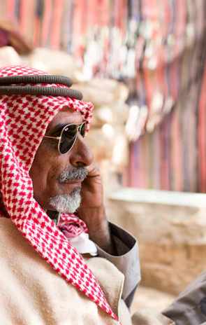 man in red and white scarf wearing gold framed aviator sunglasses