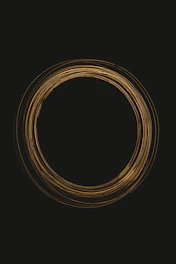 Subtle Japanese ink brush stroke forming a circle ensō behind a magnifying glass symbolizing analysis.