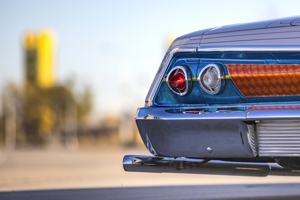 blue car on gray asphalt road during daytime