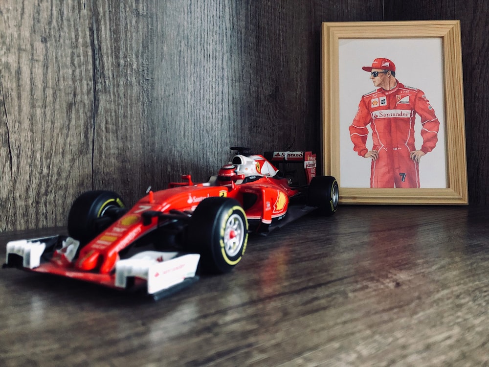 red and black f 1 car scale model