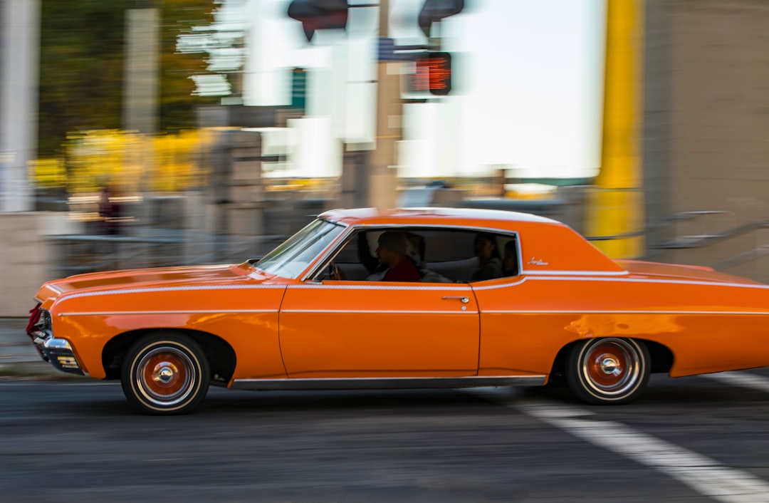 red coupe on road during daytime