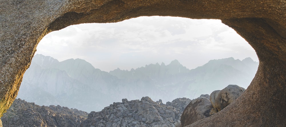 brown rock formation under white clouds during daytime