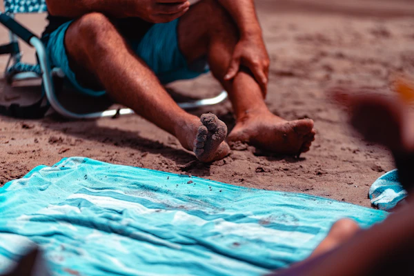 Comfortable shorts laid out on a beach towel with a sunny background.