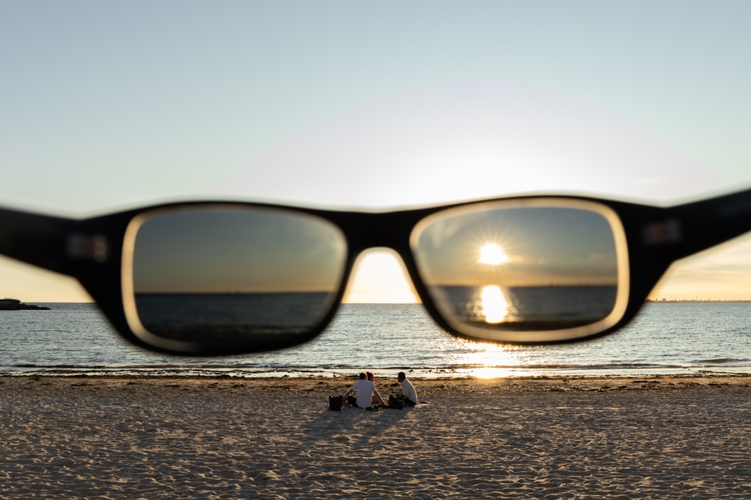 black framed sunglasses on brown wooden table