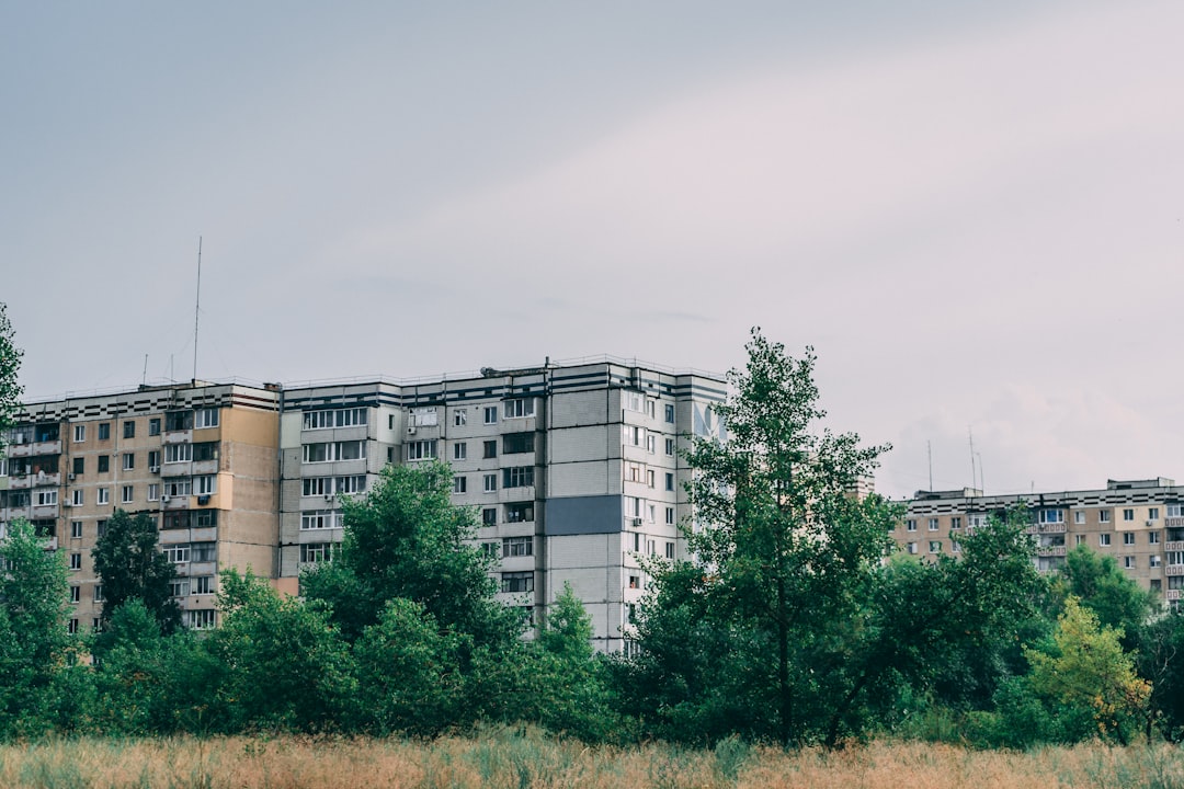 white concrete building near green trees during daytime