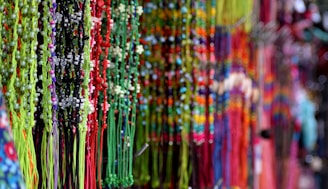 A vibrant assortment of handcrafted beads displayed on a wooden surface.