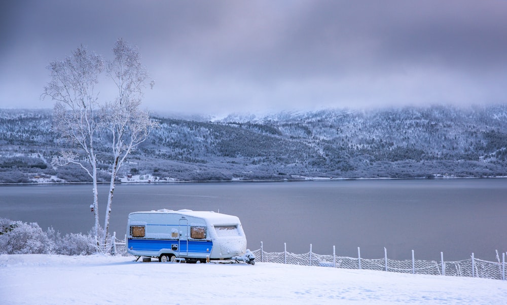 white and brown van on snow covered ground during daytime