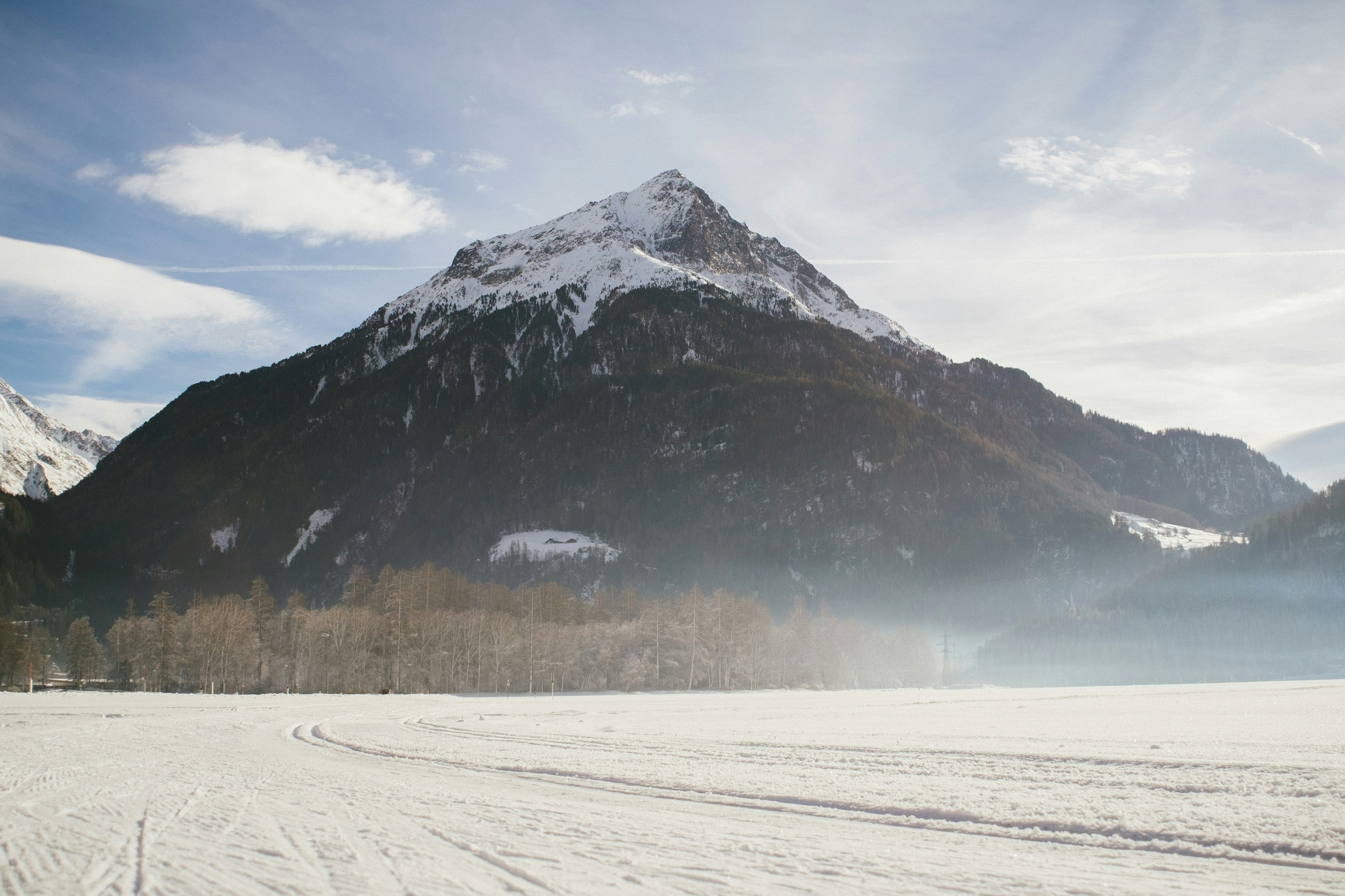 snow covered mountain under cloudy sky during daytime