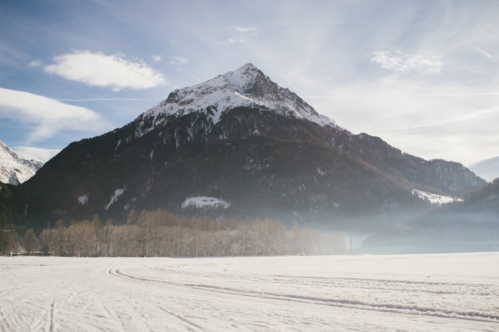 snow covered mountain under cloudy sky during daytime