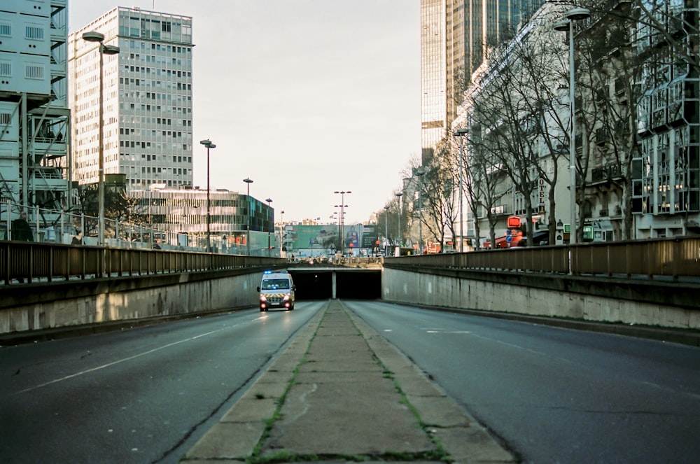 gray concrete road near high rise buildings during daytime