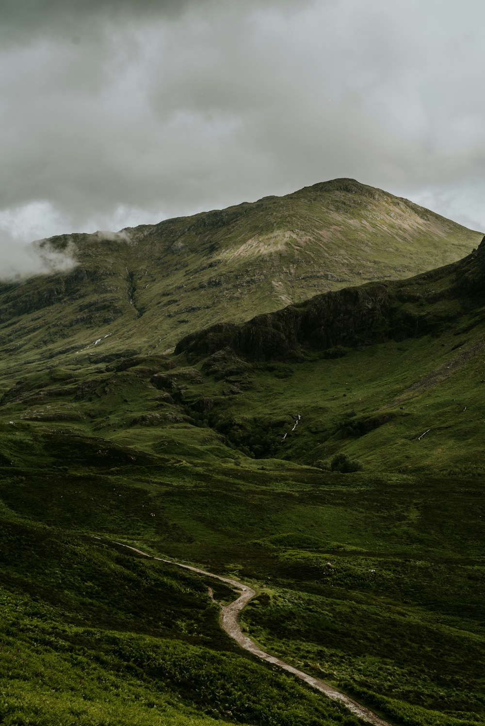 green and brown mountain under white clouds during daytime