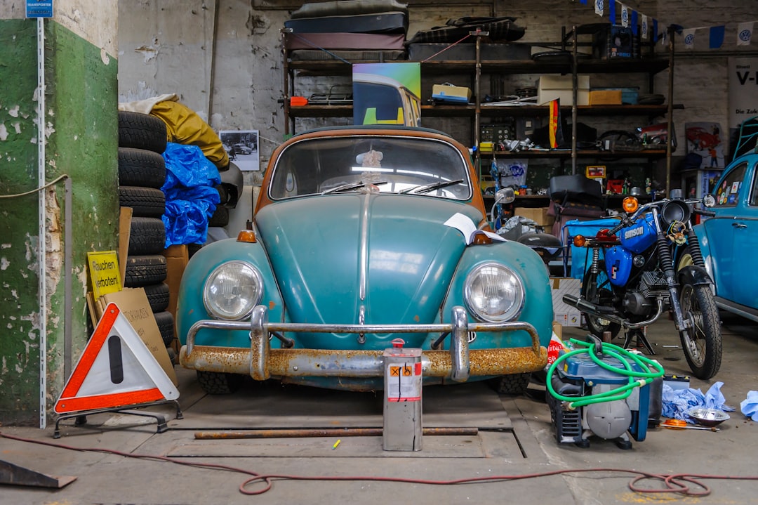 blue volkswagen beetle parked on parking lot