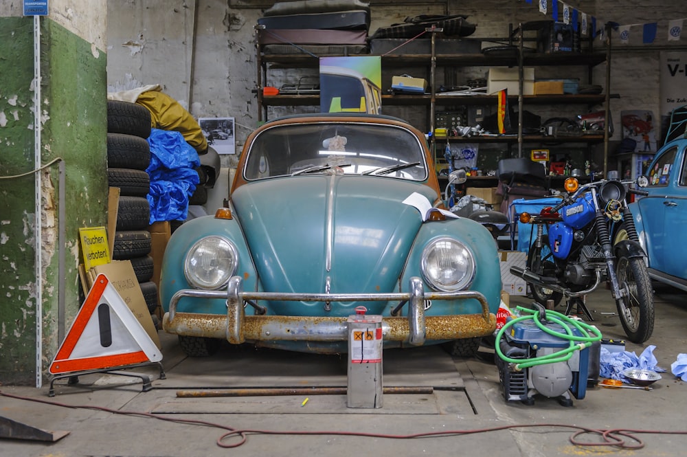 blue volkswagen beetle parked on parking lot