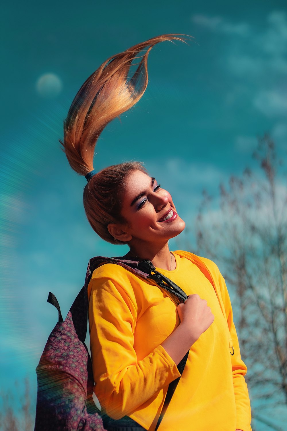 woman in yellow and black shirt smiling