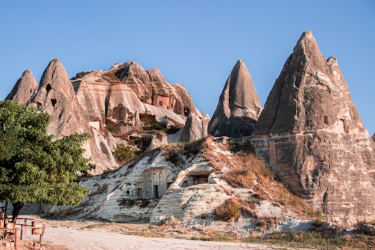 brown rock formation under blue sky during daytime in Cappadocia Turkey