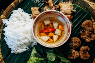 white noodles with meat and vegetables on white ceramic bowl