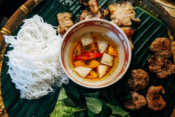 Bun Cha - Vietnames noodles with grilled meat and vegetables in a white bowl